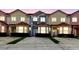 Townhomes displaying colorful exteriors and matching terracotta roofing at 1180 S Beach Cir, Kissimmee, FL 34746