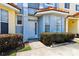 Charming townhouse exterior with a light blue facade, a bay window, and landscaped bushes at 1180 S Beach Cir, Kissimmee, FL 34746