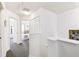 Upstairs hallway features neutral walls and carpeted flooring that leads to a bedroom at 1180 S Beach Cir, Kissimmee, FL 34746