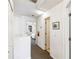 Upstairs hallway features neutral walls and carpeted flooring that leads to a bedroom at 1180 S Beach Cir, Kissimmee, FL 34746