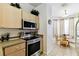 Efficient kitchen with stainless steel appliances and a view of the breakfast nook at 1180 S Beach Cir, Kissimmee, FL 34746