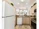Bright kitchen featuring a stainless steel oven, and adjacent staircase at 1180 S Beach Cir, Kissimmee, FL 34746