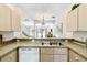 Charming kitchen featuring granite countertops and stainless steel sink at 1180 S Beach Cir, Kissimmee, FL 34746