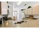 Kitchen featuring a double sink, granite countertops, and an adjacent dining room at 1180 S Beach Cir, Kissimmee, FL 34746