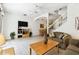 Comfortable living room with neutral decor, a ceiling fan, a television, and easy access to the dining area and stairway at 1180 S Beach Cir, Kissimmee, FL 34746