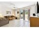 Spacious living room with tile flooring, neutral decor, and sliding doors, opening to the patio at 1180 S Beach Cir, Kissimmee, FL 34746