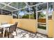 Enclosed patio with seating, ideal for outdoor relaxation, offering access to a grassy area through a screen door at 1180 S Beach Cir, Kissimmee, FL 34746