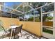 Outdoor patio with comfortable seating and a screened enclosure, perfect for enjoying the pleasant views of the backyard at 1180 S Beach Cir, Kissimmee, FL 34746