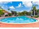 Inviting community pool surrounded by manicured landscaping and comfortable lounge chairs at 1180 S Beach Cir, Kissimmee, FL 34746