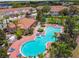 Aerial view showcasing community pool, tennis court, and clubhouse surrounded by beautiful landscaping at 1180 S Beach Cir, Kissimmee, FL 34746