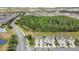 A beautiful aerial view of the property showing townhomes bordering a lush green space with a treeline at 12307 Turtle Grass Dr, Orlando, FL 32824