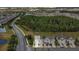 Aerial view of townhomes nestled within a community with green spaces and mature trees at 12307 Turtle Grass Dr, Orlando, FL 32824