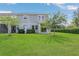 Well-manicured backyard with lush green grass, mature trees, and privacy bushes, offering a peaceful outdoor retreat at 12307 Turtle Grass Dr, Orlando, FL 32824