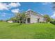 Expansive backyard featuring a well-maintained lawn, creating a perfect outdoor oasis for recreation and leisure at 12307 Turtle Grass Dr, Orlando, FL 32824