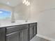 Bathroom featuring a double vanity with modern fixtures and a large mirror at 12307 Turtle Grass Dr, Orlando, FL 32824