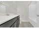 Bathroom with a quartz countertop vanity, a toilet and a tiled bathtub/shower combo at 12307 Turtle Grass Dr, Orlando, FL 32824