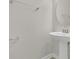 Bright bathroom featuring a pedestal sink, oval mirror and modern towel bar at 12307 Turtle Grass Dr, Orlando, FL 32824