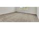 Spacious carpeted bedroom with two large windows at 12307 Turtle Grass Dr, Orlando, FL 32824