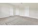Bedroom featuring plush carpeting and three bright white doors at 12307 Turtle Grass Dr, Orlando, FL 32824