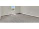 Carpeted bedroom with a window overlooking a treed landscape at 12307 Turtle Grass Dr, Orlando, FL 32824