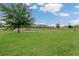 Spacious dog park with lush grass and benches, offering a secure and enjoyable space for dogs to play and socialize at 12307 Turtle Grass Dr, Orlando, FL 32824