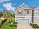 Well-manicured lawn compliments the contemporary facade of this two-story townhome at 12307 Turtle Grass Dr, Orlando, FL 32824
