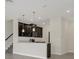 Open-concept kitchen design with modern pendant lighting, stainless appliances, and breakfast bar at 12307 Turtle Grass Dr, Orlando, FL 32824