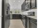 Stylish kitchen with stainless steel appliances, dark cabinets, and eat-in space at 12307 Turtle Grass Dr, Orlando, FL 32824