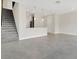 Bright and airy living space with staircase leading to upper level and open kitchen at 12307 Turtle Grass Dr, Orlando, FL 32824