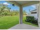 Covered patio overlooking a lush green yard and landscaping, providing a serene outdoor space for relaxation and enjoyment at 12307 Turtle Grass Dr, Orlando, FL 32824