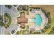 A high angle aerial view showing a community pool with ample seating surrounded by mature landscaping at 12307 Turtle Grass Dr, Orlando, FL 32824