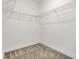 Walk-in closet with wall mounted metal shelving and carpeted floor at 12307 Turtle Grass Dr, Orlando, FL 32824