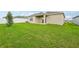 Backyard featuring a full green lawn, white fence perimeter and an outdoor living space at 1247 Blue Daze Ln, Eustis, FL 32726