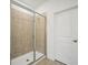 Shower featuring glass doors, tile surround, and a modern shower head at 1247 Blue Daze Ln, Eustis, FL 32726