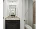 Well-lit bathroom with granite vanity, modern hardware, and a full tub with tiled surround at 1247 Blue Daze Ln, Eustis, FL 32726