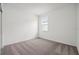 Empty bedroom with a window, carpet floors and neutral paint ready for your design at 1247 Blue Daze Ln, Eustis, FL 32726