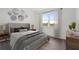Bright bedroom with a large window, neutral walls, and stylish furnishings, including a queen size bed at 1247 Blue Daze Ln, Eustis, FL 32726