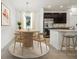 A dining room with modern decor and a view of the kitchen, including stainless steel appliances at 1247 Blue Daze Ln, Eustis, FL 32726