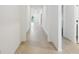 Long hallway with tile floors with a view to the outside at 1247 Blue Daze Ln, Eustis, FL 32726