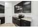 Close up of modern kitchen with stainless steel microwave and oven plus granite countertops and dark cabinets at 1247 Blue Daze Ln, Eustis, FL 32726