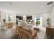 An open-concept living room features modern decor, a kitchen, and a dining room at 1247 Blue Daze Ln, Eustis, FL 32726