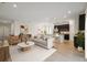 A spacious open-concept living room and kitchen features a large couch and modern decor at 1247 Blue Daze Ln, Eustis, FL 32726