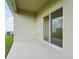 Covered patio with sliding glass door and painted concrete floor, ideal for outdoor relaxation at 1247 Blue Daze Ln, Eustis, FL 32726