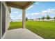 Covered patio provides relaxing view of the green backyard, making a nice outdoor living space at 1247 Blue Daze Ln, Eustis, FL 32726