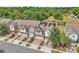 Aerial view of a row of townhomes featuring well-maintained roofs and solar panels at 1262 E 10Th St, Apopka, FL 32703