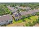 Aerial shot of townhomes with solar panels, green lawns and mature trees at 1262 E 10Th St, Apopka, FL 32703