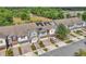Aerial view of townhomes, showcasing solar panels, garages, and street parking at 1262 E 10Th St, Apopka, FL 32703
