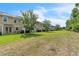 Long backyard view of townhomes with manicured lawns and privacy bushes at 1262 E 10Th St, Apopka, FL 32703