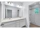 En-suite bathroom has double sinks, large mirror, and glass enclosed shower at 1262 E 10Th St, Apopka, FL 32703