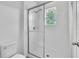Bright bathroom features a glass-enclosed shower and a window for natural light at 1262 E 10Th St, Apopka, FL 32703